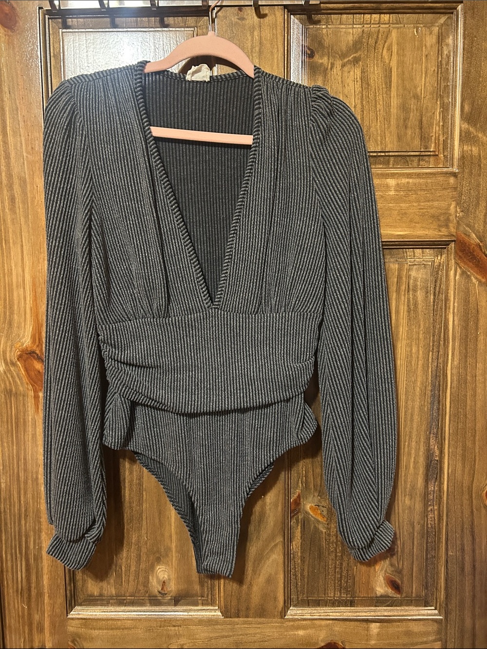 Long sleeve, deep, V- neck bodysuit.